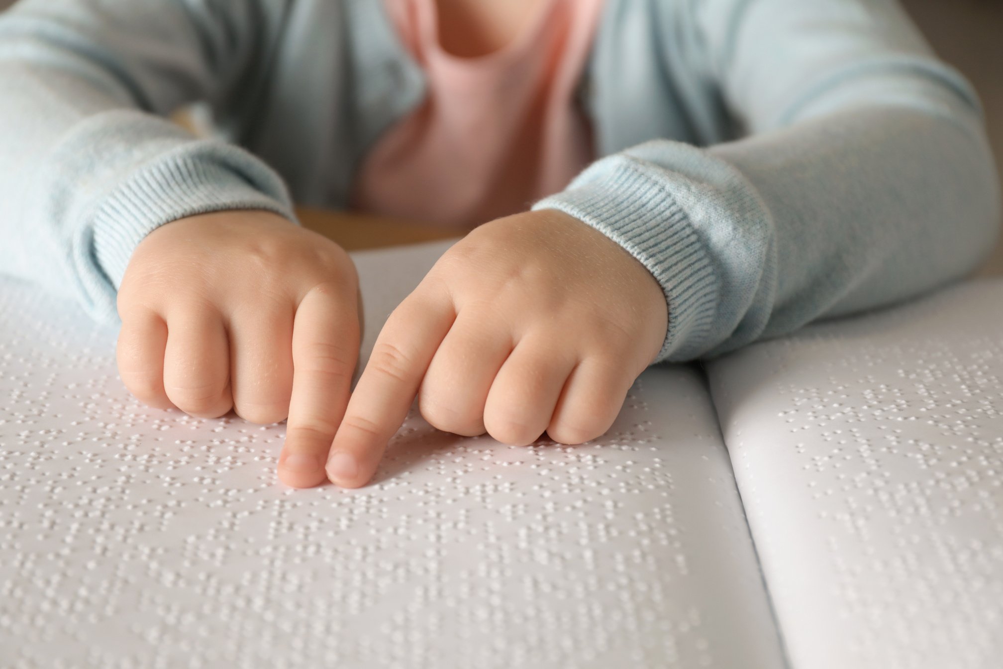 Blind Child Reading Book Written in Braille, Closeup